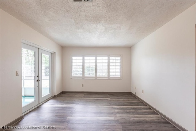1811 Jackson Dr, Sebring, FL 33870 - empty room featuring a textured ceiling, wood finished floors, and a healthy amount of sunlight