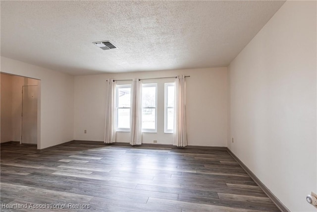 1811 Jackson Dr, Sebring, FL 33870 - empty room with baseboards, a textured ceiling, visible vents, and wood finished floors