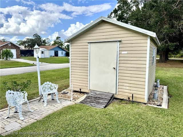 view of outbuilding featuring a lawn