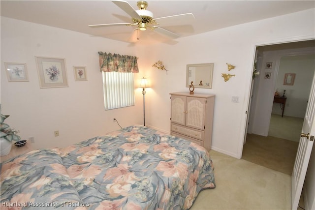 bedroom with ceiling fan and light colored carpet