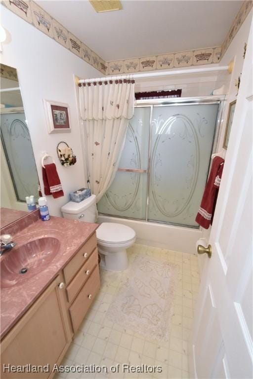 full bathroom with vanity, combined bath / shower with glass door, and toilet