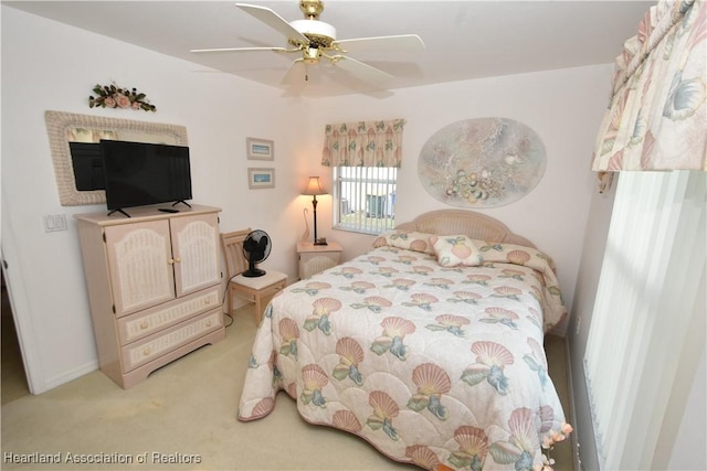 bedroom with ceiling fan and light carpet