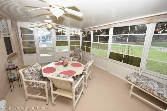 sunroom / solarium featuring a healthy amount of sunlight and ceiling fan