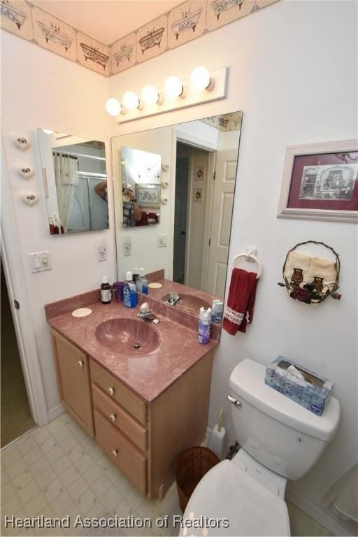 bathroom with vanity and toilet