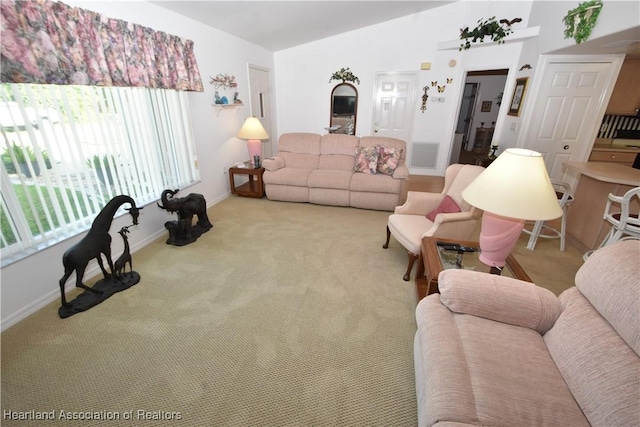 living room featuring vaulted ceiling and carpet floors