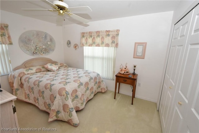 carpeted bedroom with a closet and ceiling fan