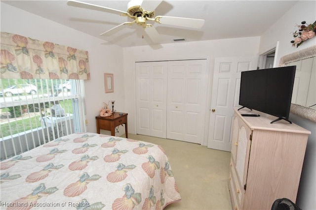 bedroom with light carpet, a closet, and ceiling fan