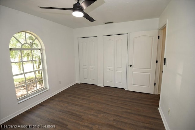 1922 N Torrington Rd, Avon Park, FL 33825 - unfurnished bedroom featuring multiple closets, dark wood-style floors, and ceiling fan