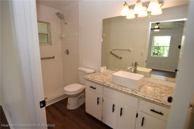 1922 N Torrington Rd, Avon Park, FL 33825 - full bathroom featuring a tile shower, vanity, ceiling fan, wood finished floors, and a chandelier