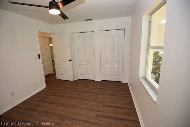 1922 N Torrington Rd, Avon Park, FL 33825 - unfurnished bedroom with two closets, dark wood-style flooring, and ceiling fan