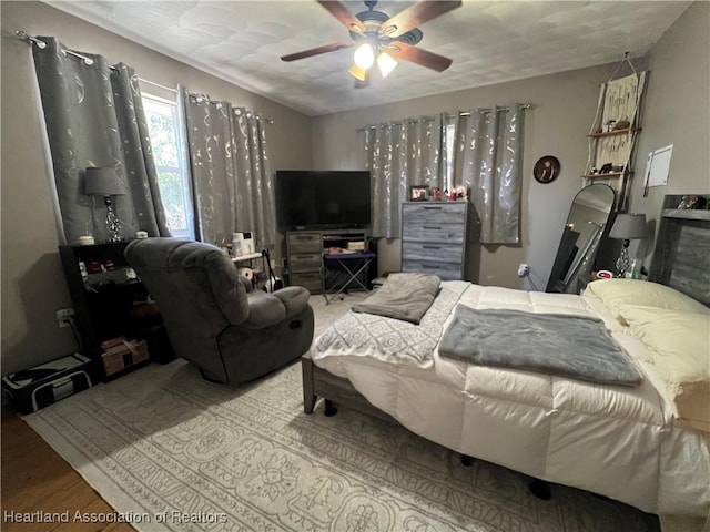 bedroom featuring hardwood / wood-style floors and ceiling fan