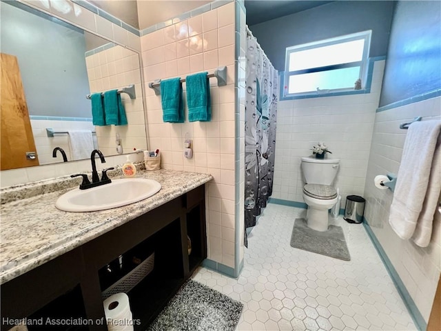 full bathroom with tile patterned flooring, toilet, tile walls, and vanity