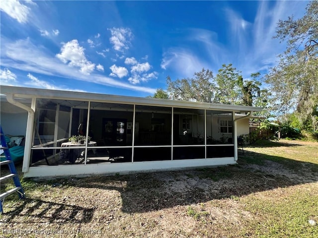 rear view of house featuring a sunroom