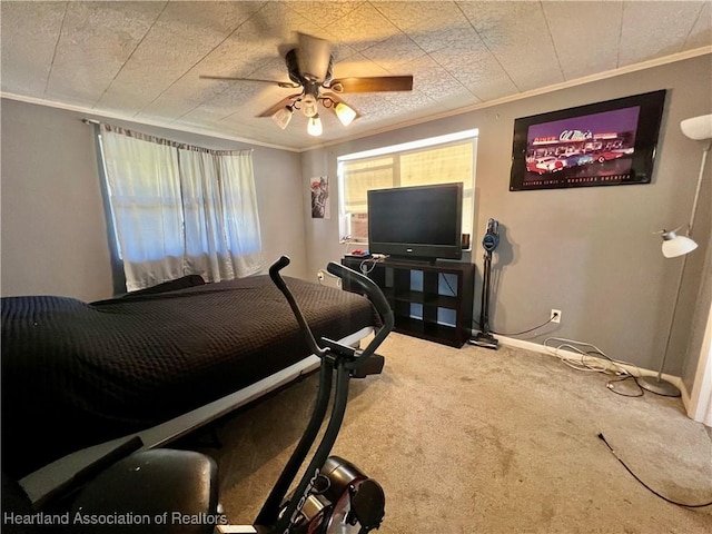 bedroom featuring carpet floors, crown molding, baseboards, and ceiling fan