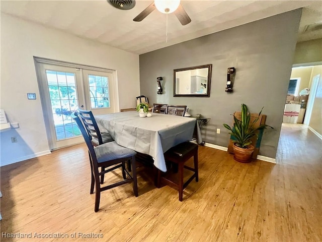 dining area with ceiling fan, light wood-style flooring, and baseboards