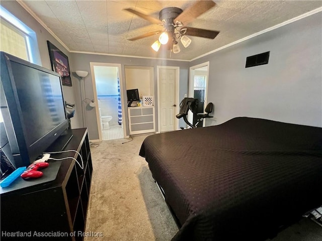 bedroom featuring light carpet, a ceiling fan, crown molding, and ensuite bathroom