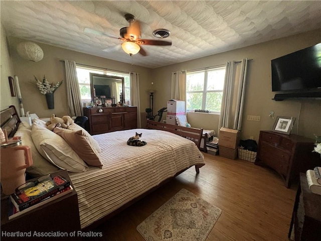 bedroom with hardwood / wood-style flooring and ceiling fan