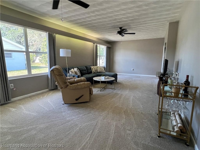 living room with light colored carpet, plenty of natural light, and ceiling fan