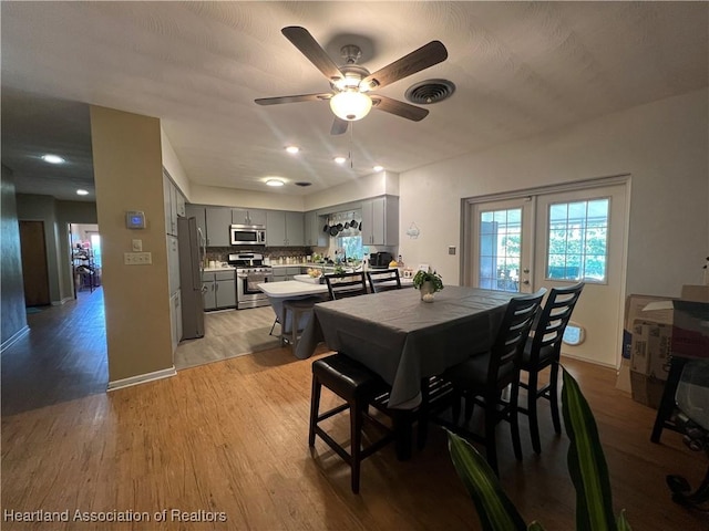 dining area featuring ceiling fan and light hardwood / wood-style flooring