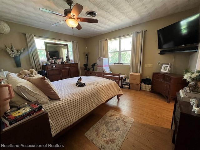 bedroom featuring light wood-type flooring and ceiling fan