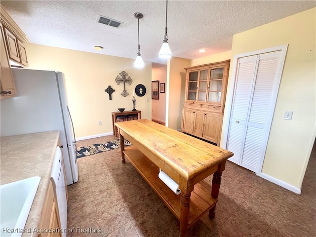 interior space featuring sink and a textured ceiling