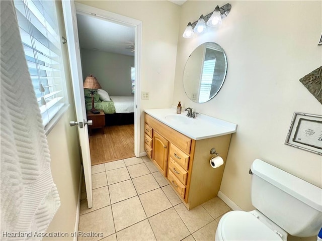 bathroom with tile patterned floors, vanity, and toilet