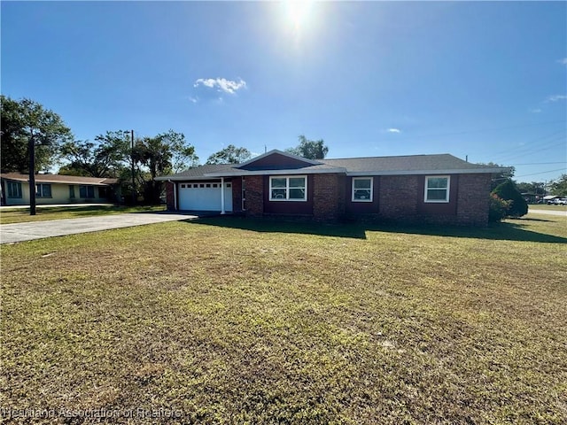 single story home with a front yard and a garage