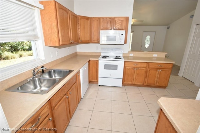 kitchen with sink, white appliances, ceiling fan, and light tile patterned flooring