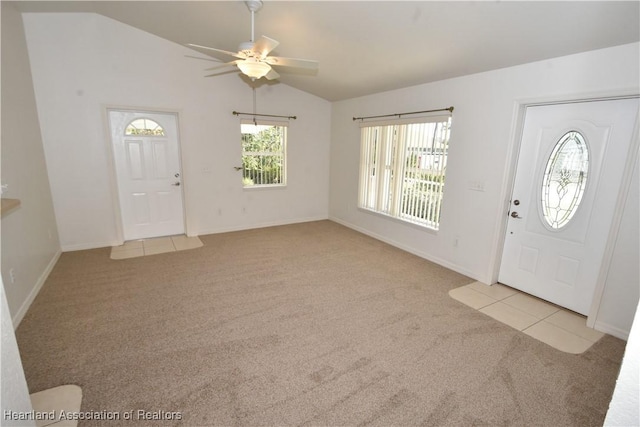 carpeted foyer entrance with vaulted ceiling and ceiling fan