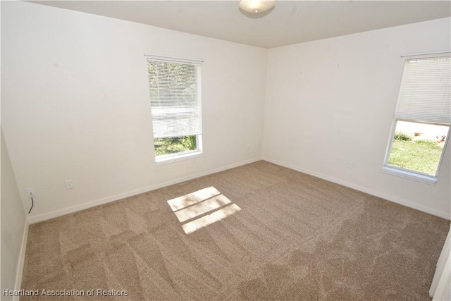 unfurnished room with light colored carpet