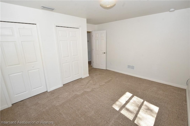 unfurnished bedroom with light colored carpet