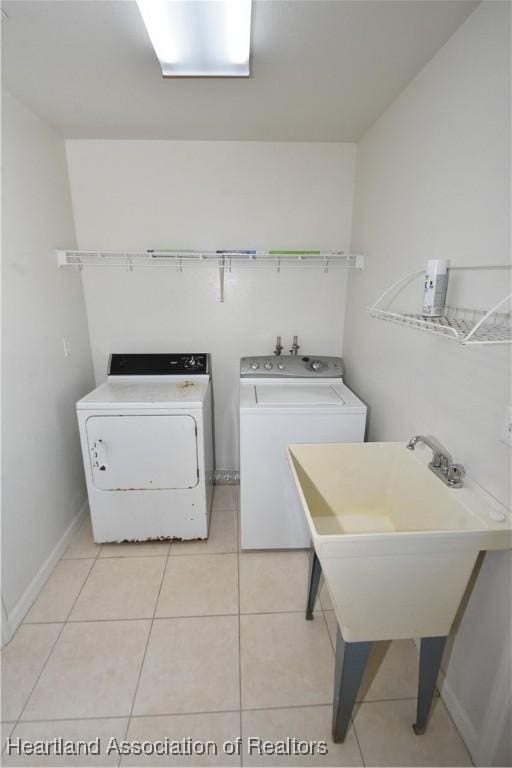 washroom with light tile patterned flooring and washing machine and dryer