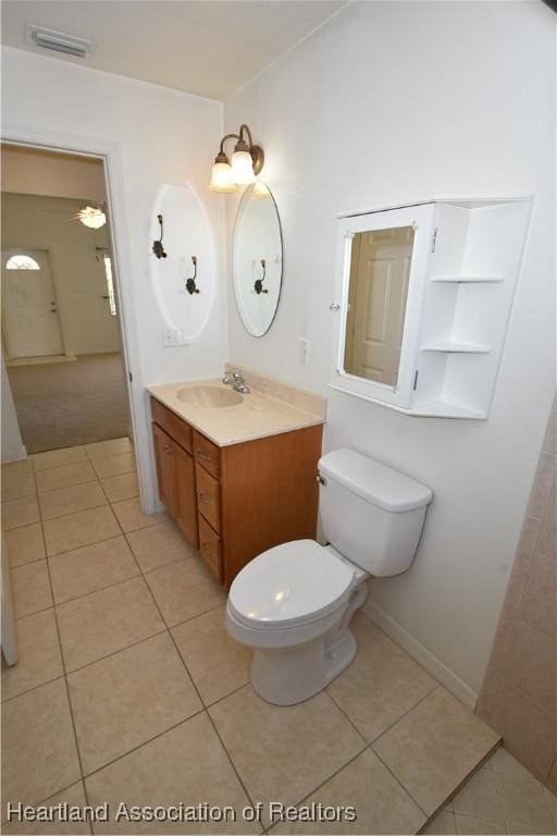 bathroom with vanity, toilet, and tile patterned flooring