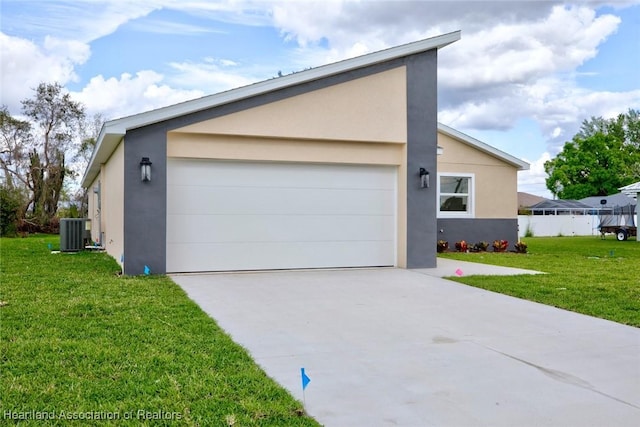 view of front of house with an attached garage, central air condition unit, driveway, stucco siding, and a front yard