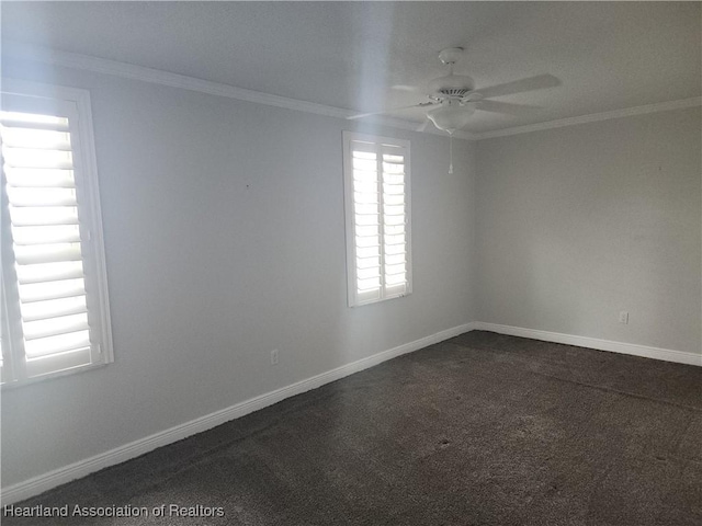 empty room featuring a ceiling fan, ornamental molding, and dark carpet