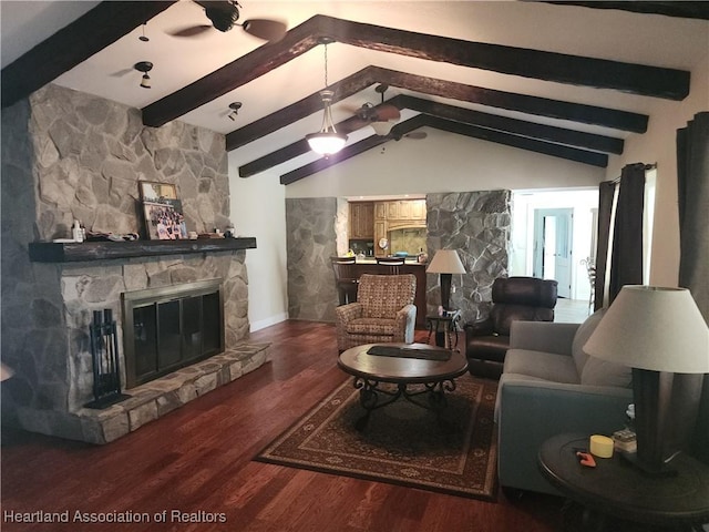 living area featuring a stone fireplace and wood finished floors