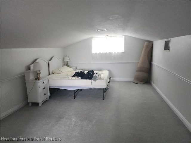 carpeted bedroom featuring vaulted ceiling and baseboards