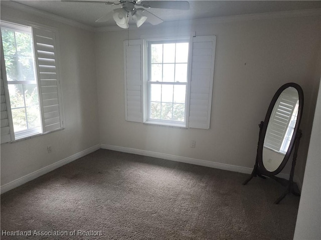 empty room featuring carpet floors, ornamental molding, and a ceiling fan