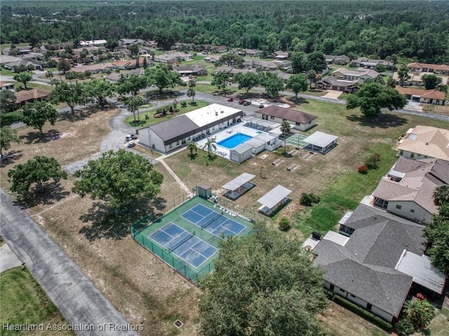 bird's eye view featuring a wooded view and a residential view