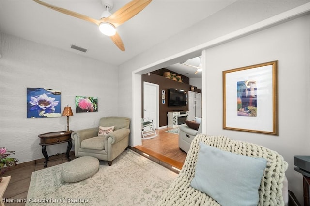 living area with wood finished floors, ceiling fan, and visible vents