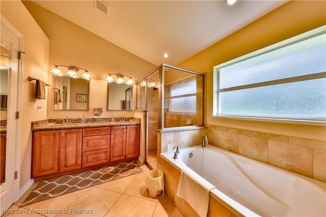 bathroom with tile patterned flooring, vanity, lofted ceiling, and independent shower and bath