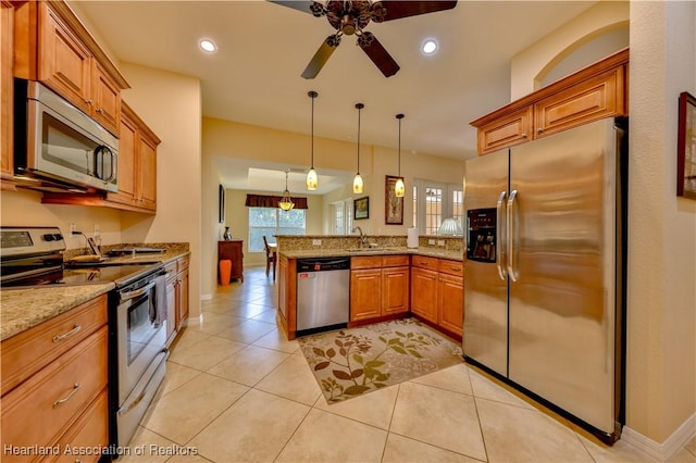 kitchen featuring kitchen peninsula, light stone countertops, stainless steel appliances, hanging light fixtures, and light tile patterned flooring