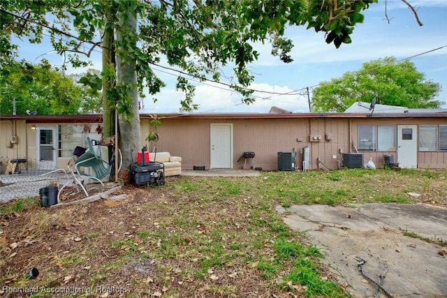 612 Denise Ave, Sebring, FL 33870 - back of house with central air condition unit and a patio area