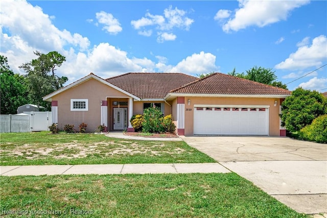 view of front of house featuring a garage and a front lawn