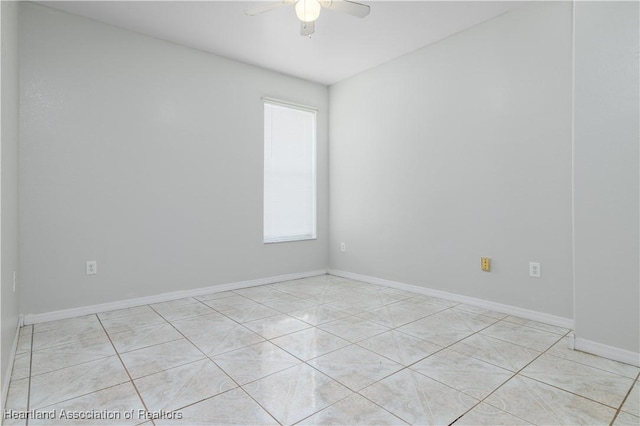 tiled spare room with ceiling fan