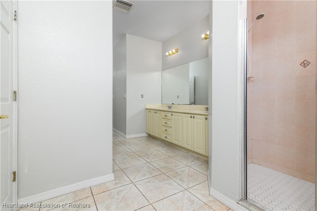 bathroom with tile patterned floors, vanity, and a shower with shower door