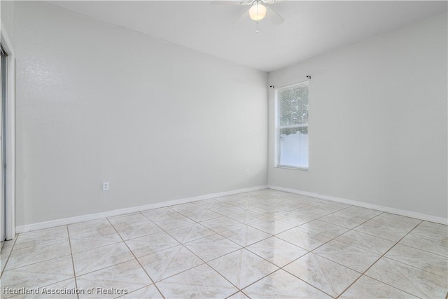 unfurnished room with ceiling fan and light tile patterned floors