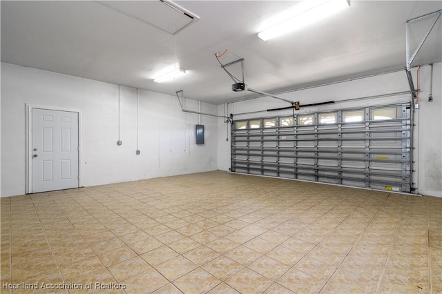 garage featuring electric panel and a garage door opener