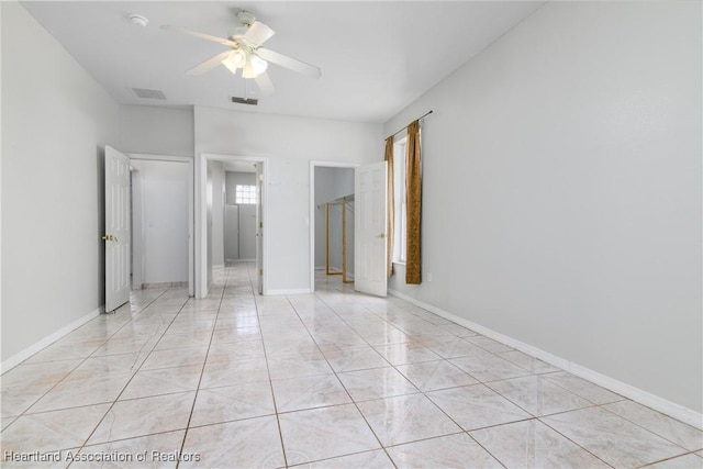 unfurnished bedroom with ceiling fan and light tile patterned floors