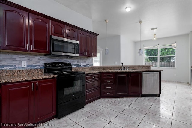 kitchen with pendant lighting, backsplash, dark stone counters, sink, and appliances with stainless steel finishes